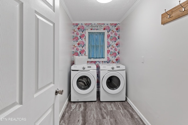 washroom with baseboards, ornamental molding, laundry area, a textured ceiling, and separate washer and dryer