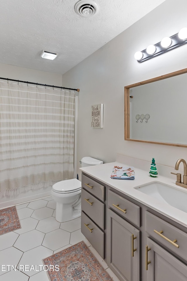 full bathroom featuring tile patterned floors, visible vents, toilet, a textured ceiling, and vanity