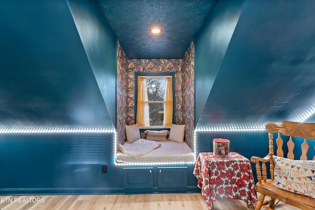 bedroom with wood finished floors and a textured ceiling