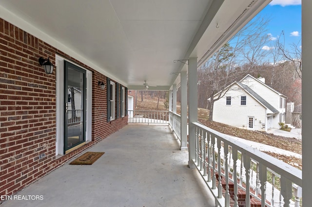 balcony with a ceiling fan and covered porch