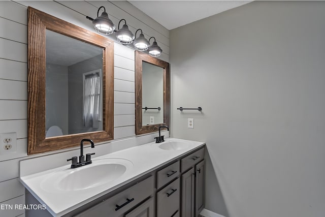 bathroom with a sink and double vanity