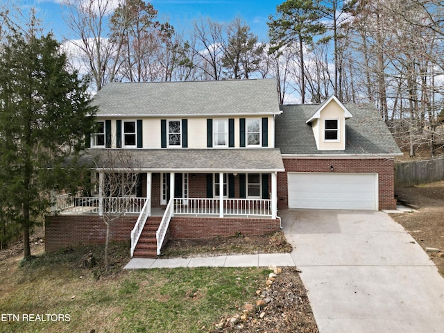 view of front facade with covered porch, concrete driveway, a shingled roof, a garage, and brick siding