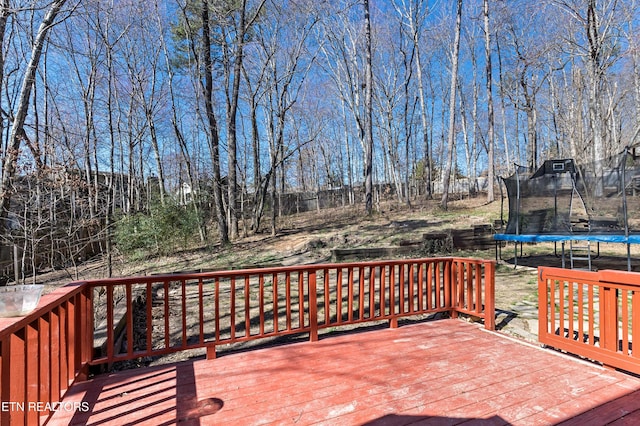 wooden terrace with a trampoline