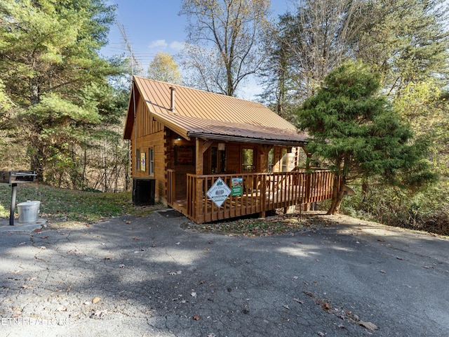 view of property exterior featuring a wooden deck