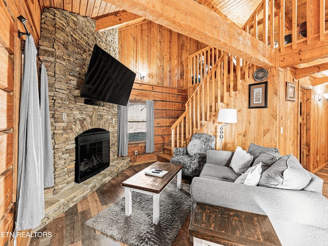 living room with wood walls, wooden ceiling, high vaulted ceiling, hardwood / wood-style flooring, and a fireplace