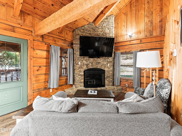 living room with wood walls, wooden ceiling, lofted ceiling with beams, a stone fireplace, and wood-type flooring