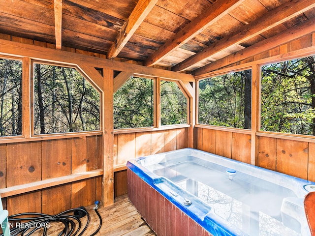 sunroom featuring beamed ceiling, wooden ceiling, and a hot tub