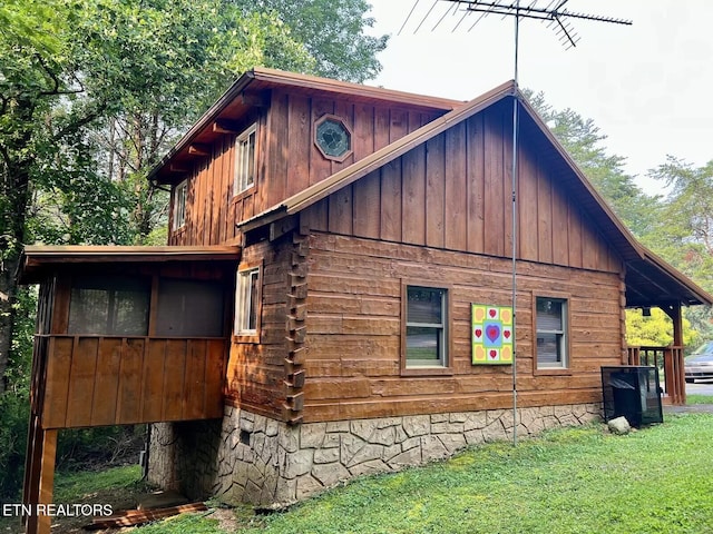 view of home's exterior with a lawn and central AC