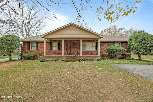 ranch-style house with a porch and a front yard