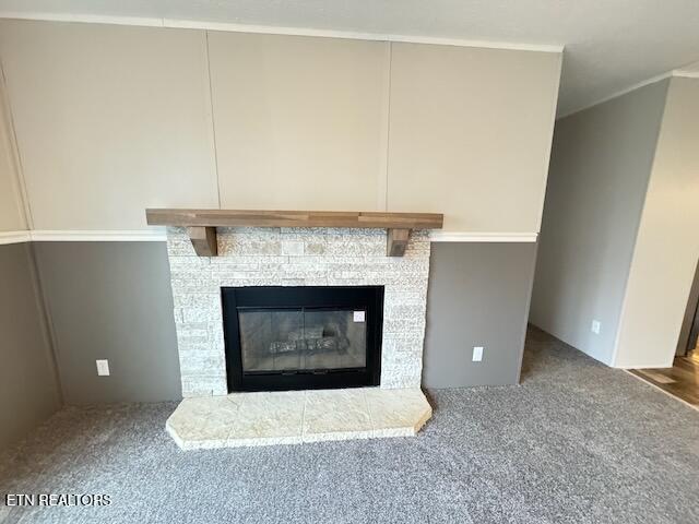 room details featuring carpet and a fireplace