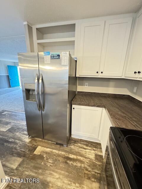 kitchen featuring white cabinetry, dark wood-type flooring, and stainless steel appliances