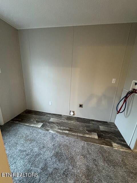 unfurnished room with dark colored carpet