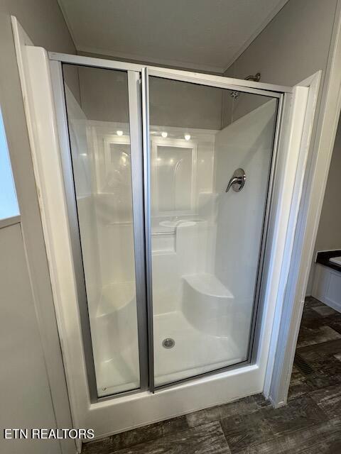 bathroom with a shower with door