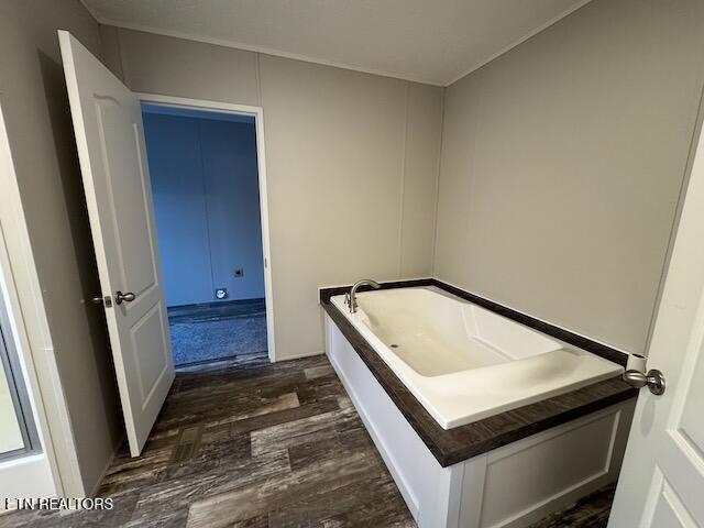 bathroom featuring a bathtub and hardwood / wood-style flooring