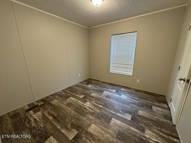 unfurnished room with ornamental molding, a textured ceiling, and dark wood-type flooring