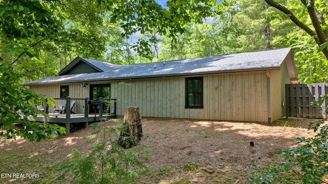 rear view of house featuring a wooden deck