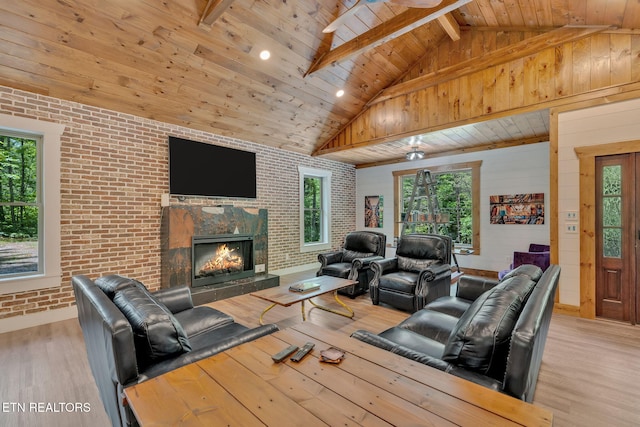 living room with light hardwood / wood-style floors, wooden ceiling, and brick wall