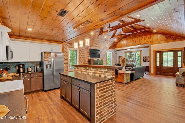 kitchen with white cabinetry, a center island, stainless steel appliances, and wooden ceiling