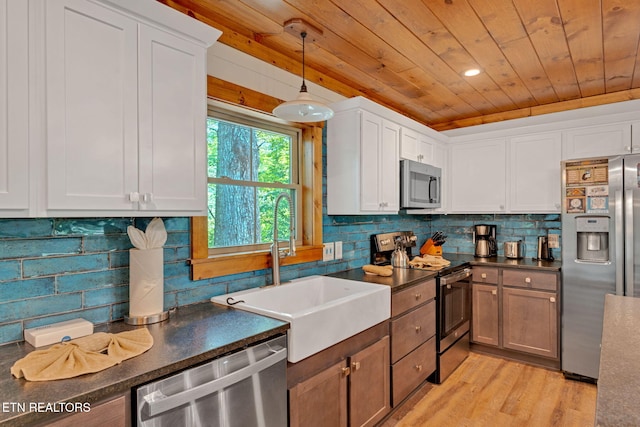 kitchen featuring white cabinets, light hardwood / wood-style floors, and appliances with stainless steel finishes