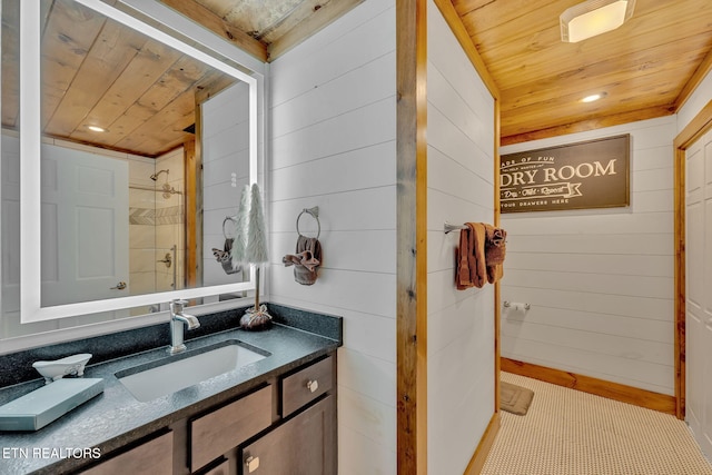 bathroom featuring vanity, walk in shower, wooden walls, and wood ceiling