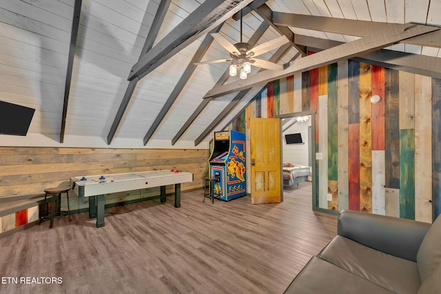 game room with hardwood / wood-style floors and wood walls