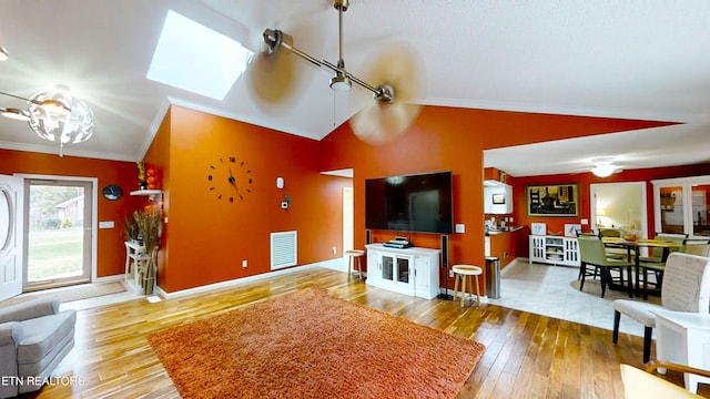 13 Windsor Pt, Crossville, TN 38558 - living area with wood-type flooring, vaulted ceiling, ornamental molding, and a chandelier