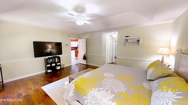 bedroom with dark hardwood / wood-style flooring and ceiling fan