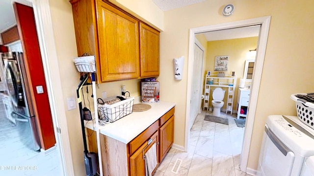 13 Windsor Pt, Crossville, TN 38558 - kitchen featuring light marble finish floors, light countertops, and brown cabinets