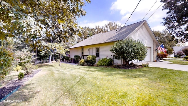 view of side of home featuring a yard and a garage