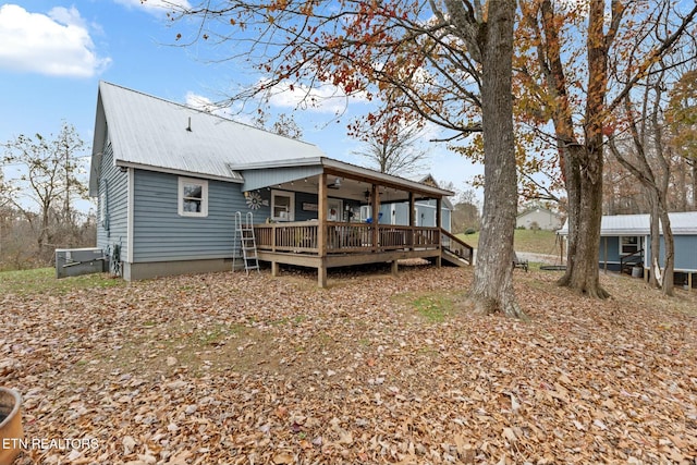 back of property with ceiling fan and a deck