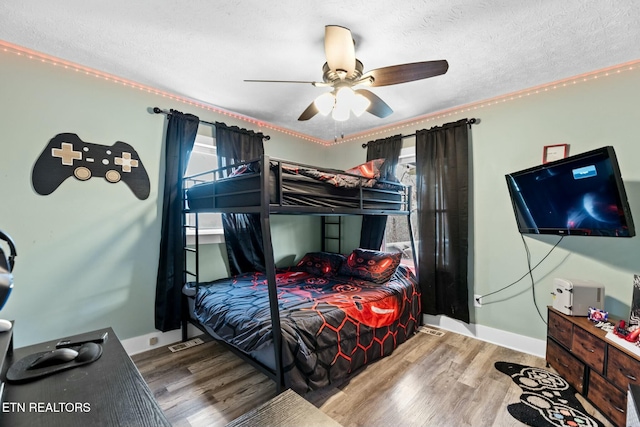 bedroom featuring ceiling fan, light hardwood / wood-style floors, and a textured ceiling