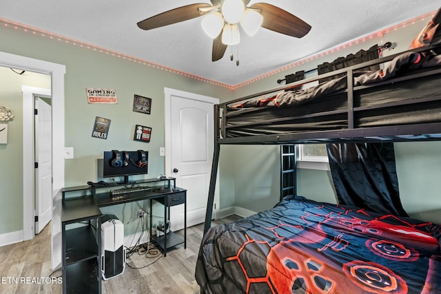 bedroom with ceiling fan and light hardwood / wood-style flooring