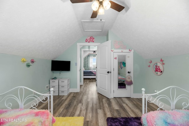 bedroom with hardwood / wood-style flooring, ceiling fan, a textured ceiling, and vaulted ceiling