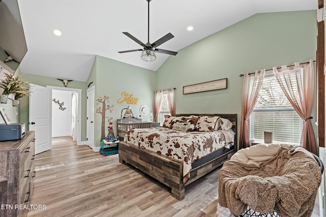 bedroom featuring ceiling fan, high vaulted ceiling, and light wood-type flooring