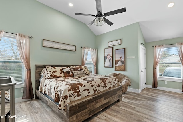 bedroom featuring light wood-type flooring, ceiling fan, and lofted ceiling