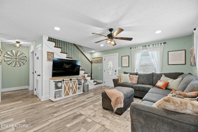 living room with light wood-type flooring and ceiling fan