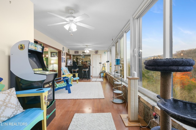 sunroom / solarium featuring ceiling fan