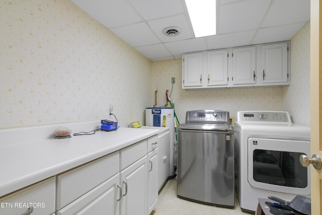 laundry area featuring washer and clothes dryer and cabinets