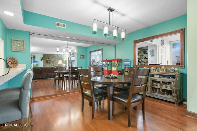 dining room featuring a textured ceiling and hardwood / wood-style flooring