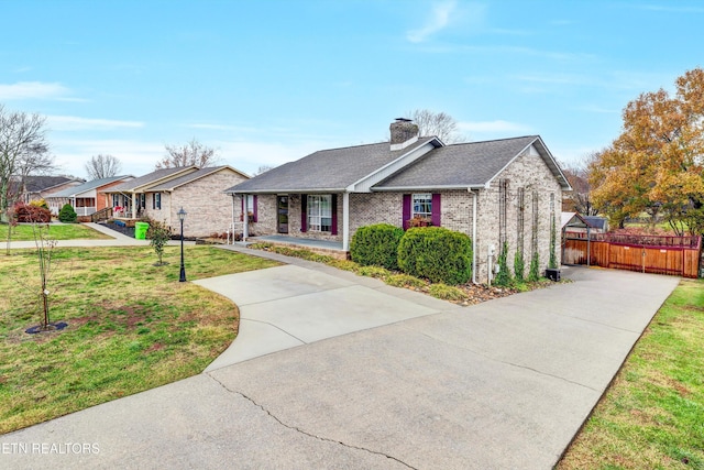 single story home featuring covered porch and a front lawn