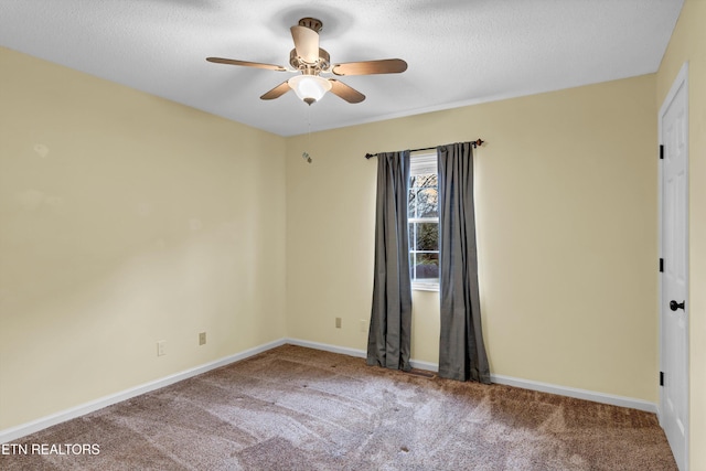 empty room featuring carpet flooring, ceiling fan, and a textured ceiling