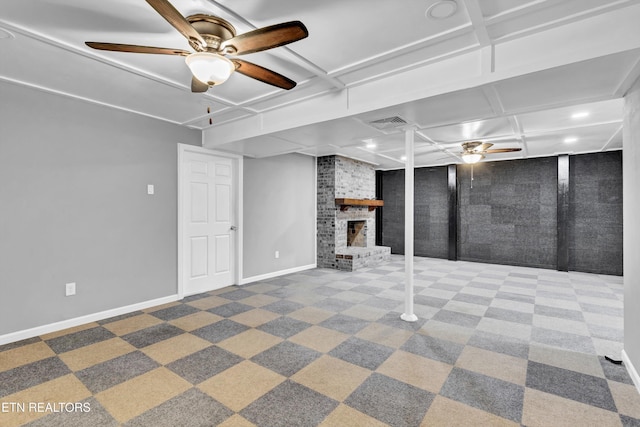 basement with carpet flooring, ceiling fan, and a fireplace