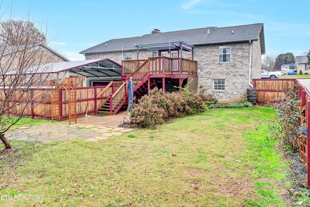 back of property with a lawn and a wooden deck