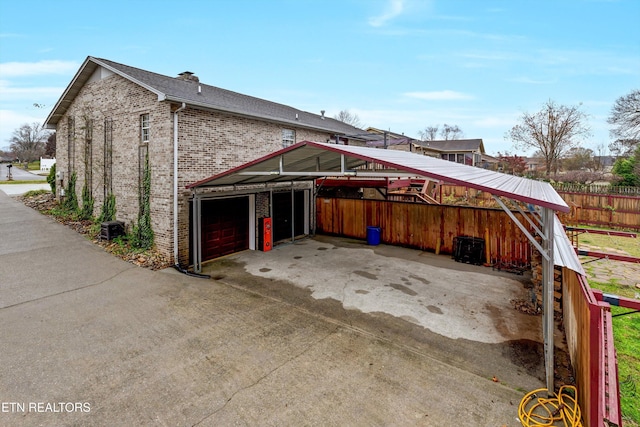 view of side of property featuring a carport and a garage