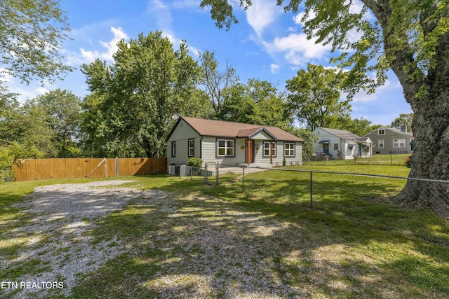 ranch-style home with central AC unit and a front lawn