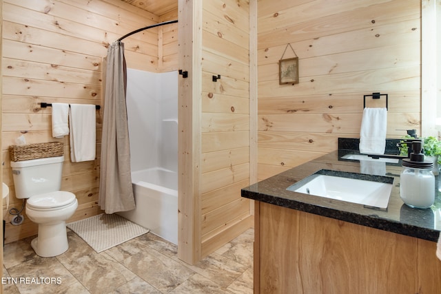 full bathroom featuring wooden walls, vanity, shower / tub combo, and toilet