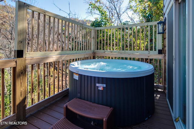 wooden deck featuring a hot tub