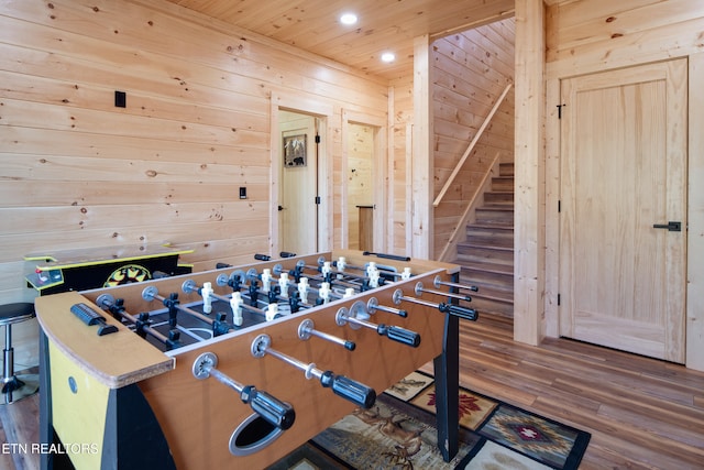 recreation room with wood walls, hardwood / wood-style floors, and wooden ceiling