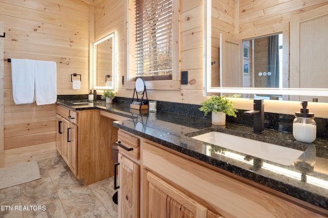 bathroom featuring wood walls and vanity