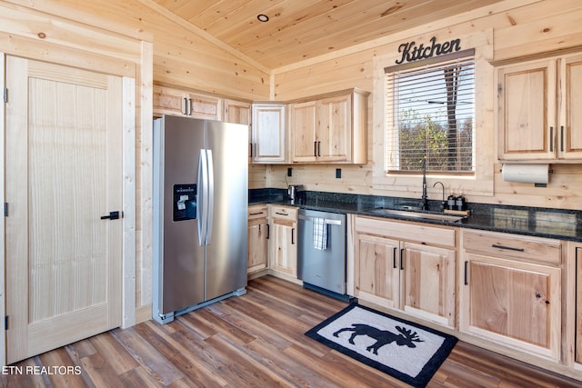 kitchen with sink, light brown cabinets, stainless steel appliances, dark stone counters, and lofted ceiling